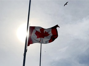 Files: The Canadian Flag flies at half-mast behind Brockville City Hall to mark the worldwide one-year anniversary of the COVID-19 pandemic.