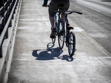 A cyclist makes his way across Champlain Bridge near Bate Island on the first weekend of spring, Sunday, March 21, 2021.