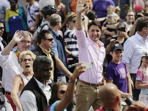 Files: Prime Minister Justin Trudeau marches for the first time in Ottawa's Capital Pride parade, with his son Xavier and daughter Ella-Grace, and joined by Mayor Jim Watson in 2017.
