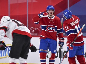 Tyler Toffoli of the Canadiens celebrates his empty-net goal with teammate Brendan Gallagher after clinching a 3-1 victory against the Senators in Montreal on Tuesday night.