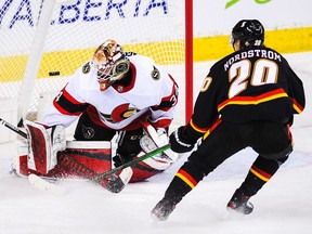 Senators netminder Joey Daccord turns back a scoring attempt by the Flames' Joakim Nordstrom during Thursday's game in Calgary.