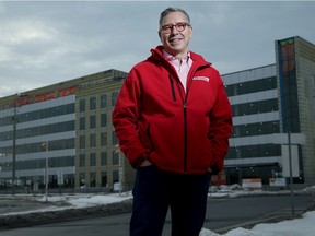 Kinaxis CEO John Sicard in front of his firm's new Kanata headquarters building in 2021. The building was completed recently, under budget, and will be able to accommodate nearly 1,000 employees post pandemic.