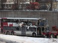 The OC Transpo bus involved in the crash at Westboro Station was towed from the scene, revealing extensive damage, on Jan. 12, 2019.