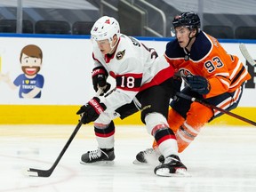Edmonton Oilers' Ryan Nugent-Hopkins chases Ottawa Senators' Tim Stuetzle during first period NHL action at Rogers Place in Edmonton, on Friday, March 12, 2021.