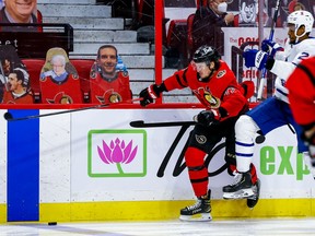 Senators defenceman Thomas Chabot gets past the check of Toronto Maple Leafs right wing Wayne Simmonds during second period NHL action at the Canadian Tire Centre on Thursday.