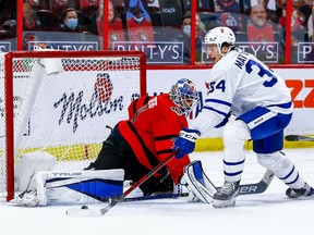 Toronto Maple Leafs center Auston Matthews is stopped by Ottawa Senators goaltender Anton Forsberg as Ottawa Senators defenceman Thomas Chabot attempts to check during overtime period NHL action at the Canadian Tire Centre.