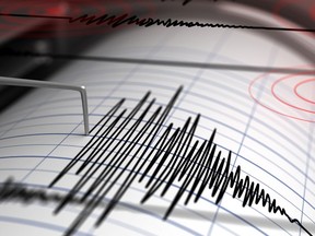 A stock image of a seismograph with paper in action.