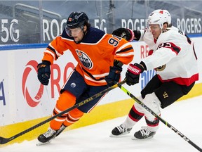 Edmonton Oilers' Gaetan Haas (91) battles Ottawa Senators' Nikita Zaitsev (22) during third period NHL action at Rogers Place in Edmonton, on Friday, March 12, 2021.