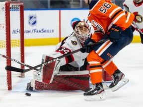 Edmonton Oilers' Kailer Yamamoto (56) is stopped by Ottawa Senators' goaltender Joey Daccord (34) during third period NHL action at Rogers Place in Edmonton, on Friday, March 12, 2021.