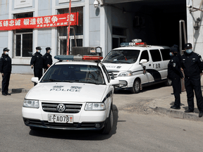 Police vehicles exit the Intermediate People's Court where Michael Spavor, a Canadian detained by China in December 2018 on suspicion of espionage, stood trial, in Dandong, China, March 19, 2021.