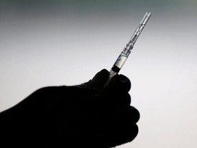 FILE: A healthcare worker prepares a dose of vaccine.