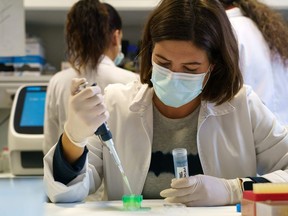 FILE: A researcher works on searching for a vaccine against COVID-19 in a laboratory.