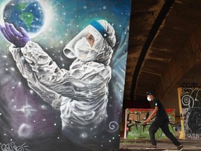 FILE: A man skates past a COVID-19 related graffiti by artist Luciano Cranio, at a skate park in Sapucaia do Sul, Rio Grande do Sul state, Brazil, on March 17, 2021.