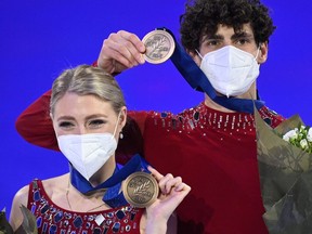 Canada's Piper Gilles and Paul Poirier, who is originally from Cornwall, pose with their bronze medals after the free ice dance skating event at the ISU World Figure Skating Championships in Stockholm on Saturday.