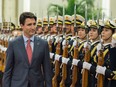 Prime Minister Justin Trudeau reviews Chinese paramilitary guards during a welcome ceremony at the Great Hall of the People in Beijing on Dec. 4, 2017.