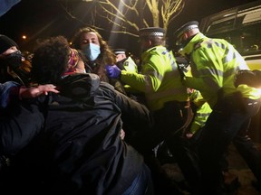 People clash with police during a gathering at a memorial site in Clapham Common Bandstand, following the kidnap and murder of Sarah Everard, in London, Britain on Sunday.