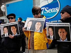 FILE PHOTO: People hold placards calling for China to release Canadian detainees Michael Spavor and Michael Kovrig outside a court hearing for Huawei Technologies Chief Financial Officer Meng Wanzhou at the B.C. Supreme Court in Vancouver, British Columbia, Canada, March 6, 2019.