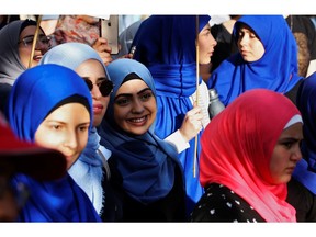 Women and men alike protested Quebec's Bill 21, banning teachers, police, government lawyers and others in positions of authority from wearing religious symbols such as Muslim head coverings and Sikh turbans.