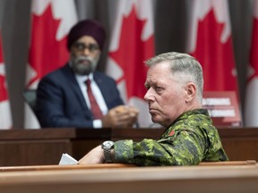 National Defence Minister Harjit Sajjan and then-chief of Defence Staff Jonathan Vance listen to a question during a news conference in June 2020.