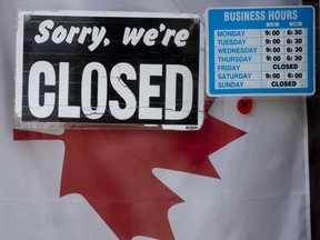 A file photo of a "closed" sign in a store window in Ottawa in April 2020.