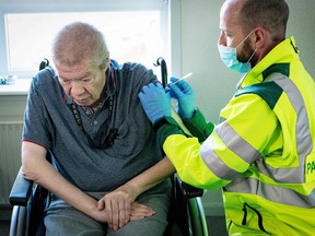 Aage Steen Jensen, a 67-year-old kidney patient, is vaccinated in his own home in Aalborg, Denmark on March 5, 2021.