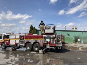 Firefighters on the scene of a fire in a vacant commercial building on Merivale Road