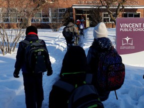 Students walk into Vincent Massey Public School on Smyth Road in Ottawa in mid-February.