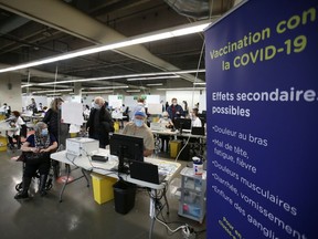 People are vaccinated at Olympic Stadium for coronavirus disease (COVID-19).