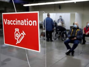 People wait after being vaccinated at the Olympic Stadium for COVID-19 as Quebec begins vaccinations for seniors in Montreal, Canada March 1, 2021.