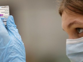 FILE: A medical worker prepares a dose of Oxford/AstraZeneca's COVID-19 vaccine.