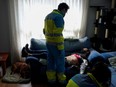 Madrid Emergency Service (SUMMA) UVI-3 unit's Dr Navid Behzadi Koochani treats a patient inside his home during the coronavirus disease (COVID-19) outbreak in Madrid, Spain, March 2, 2021. "These are situations that affect you emotionally... You're there the next day thinking over how fragile life really is and, on the other hand, how lucky we are to be alive," said Behzadi.