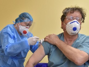 A medical worker receives a dose of the AstraZeneca vaccine against the coronavirus disease (COVID-19) at a hospital in Lviv, Ukraine, March 1, 2021.