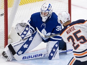 Edmonton Oilers defenceman Darnell Nurse (25) scores the game winning goal on Toronto Maple Leafs goaltender Michael Hutchinson (30) during overtime NHL action in Toronto on Monday March 29, 2021.