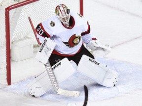 Ottawa Senators forward Connor Brown dodges a shot in front of Calgary Flames goalie David Rittich during the second period at Scotiabank Saddledome on Thursday.