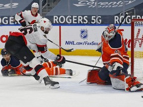 Files:  Edmonton Oilers goaltender Mike Smith (41) makes a save on Ottawa Senators forward Austin Watson (16) during the second period in Edmonton on March 12, 2021.