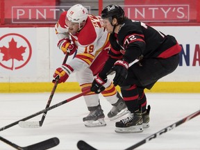 Flames left-winger Matthew Tkachuk gets cut off by Senators defenceman Thomas Chabot in the first period of Monday's game.