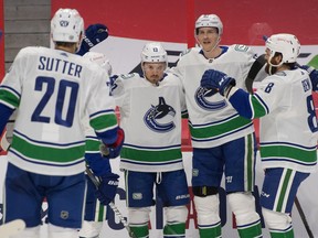 Vancouver Canucks center Jayce Hawryluk (13) celebrates with teammates after scoring against the Ottawa Senators in the first period at the Canadian Tire Centre on Monday.