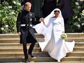 In this file photo taken on May 19, 2018 Britain's Prince Harry, Duke of Sussex and his wife Meghan, Duchess of Sussex emerge from the West Door of St George's Chapel, Windsor Castle, in Windsor, on May 19, 2018 after their wedding ceremony.