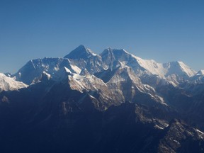 FILE PHOTO: Mount Everest, the world's highest peak, and other peaks of the Himalayan range are seen through an aircraft window during a mountain flight from Kathmandu, Nepal January 15, 2020.