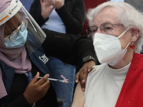 File: Norma O'Connor receives a COVID-19 vaccine from Ottawa Public Health at the The Albion-Heatherington Recreation Centre in Ottawa Friday March 5, 2021.