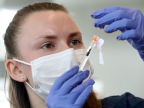 Student CHEO pharmacist Alicia Davis preparing the Pfizer-BioNTech Covid-19 Vaccine at the Albion-Heatherington Recreation Centre in Ottawa Friday March 5, 2021.