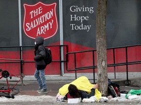 A man without shelter huddles on George Street on a winter day earlier this year.