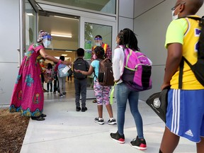 Teachers and students outside École Horizon-Jeunesse in Ottawa on Thursday, Sept 3, 2020.