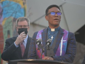 Rev. Anthony Bailey of Parkdale United Church speaks at Thursday's memorial interfaith service commemorating the anniversary of the first COVID-19 death in Ottawa while Mayor Jim Watson looks on.