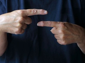 A file photo showing a demonstration of the word "about" in a standard version of American Sign Language (ASL).