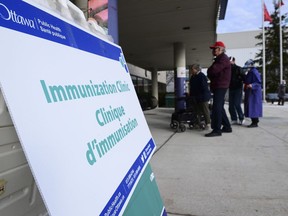 People arrive at a community COVID-19 vaccination clinic.