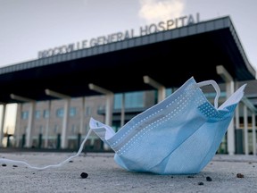 A facemask lies on the ground near the main entrance to Brockville General Hospital
