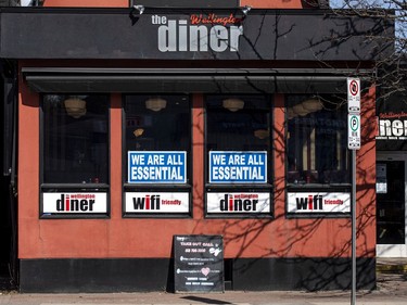 Management of the Wellington Diner on Wellington Street West make a point with some window signs on Saturday, the first day of another round of much tighter COVID-19 restrictions in Ontario.
