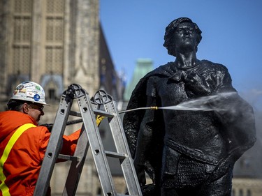 The Henry Albert Harper Memorial statue in front of Parliament Hill receives a spring cleaning on Saturday. The monument is located near the intersection of Wellington and Metcalfe streets. The statue of Sir Galahad honours Henry Albert Harper, who drowned while trying to rescue a girl who had fallen through thin ice on the Ottawa River in 1901, and it was created four years later.