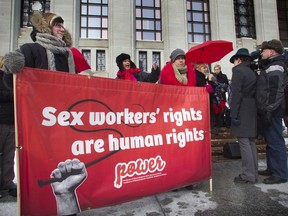 Sex workers and their supporters gathered on the front steps of the Supreme Court of Canada building in Ottawa in January, 2012 as they challenged criminal laws regarding adult prostitution. They won their case, but subsequent legislation has still made this work difficult.